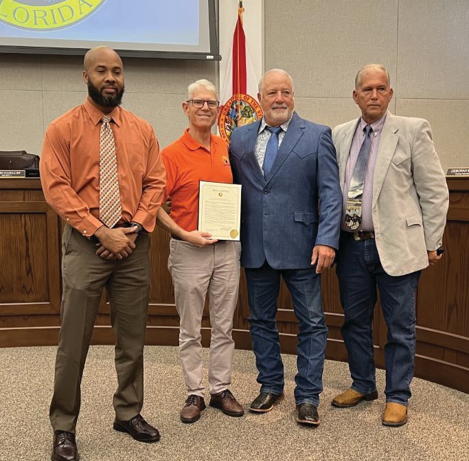 OKEECHOBEE – (Left to right) Patrick Wilson and Jonathan Bean of Martha’s House accepted the Teen Dating Violence Awareness and Prevention Month proclamation from Commissioner Frank DeCarlo and Commission Chair David Hazellief at the Jan. 26 meeting of the Okeechobee County Commission.